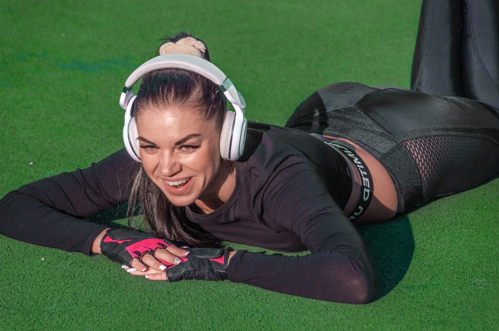 Young beautiful girl listens to music ./Athletic girl outdoors with headphones.