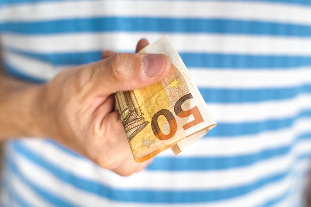 Person holding fifty euros