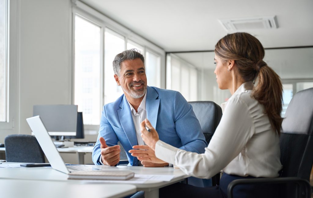 Two older executives team business people man and woman working at office corporate meeting. Happy mature business woman professional bank manager lawyer consulting client on finances management